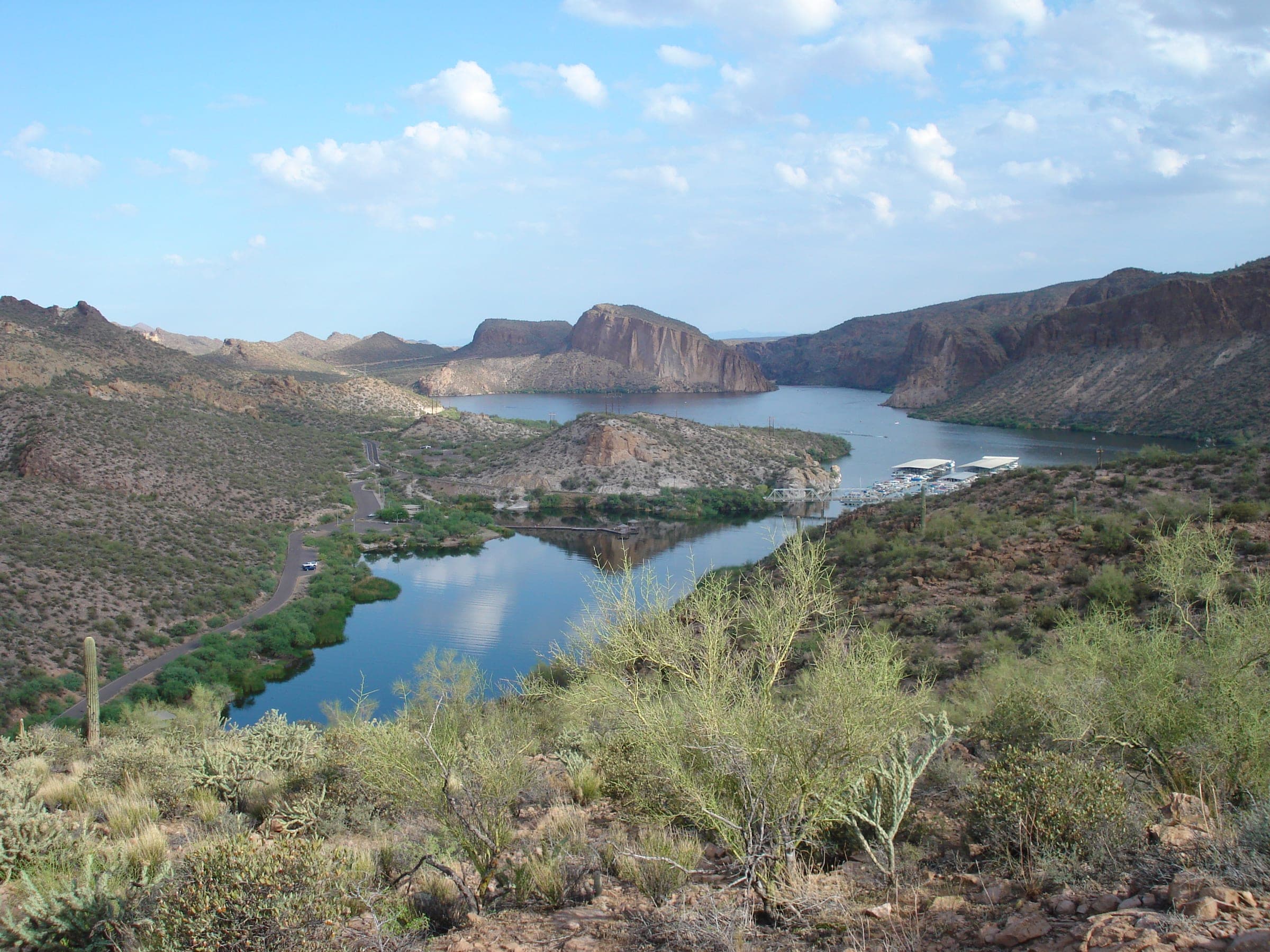 Canyon Lake winding between cliffs, with the marina and the Apache Trail along the shore