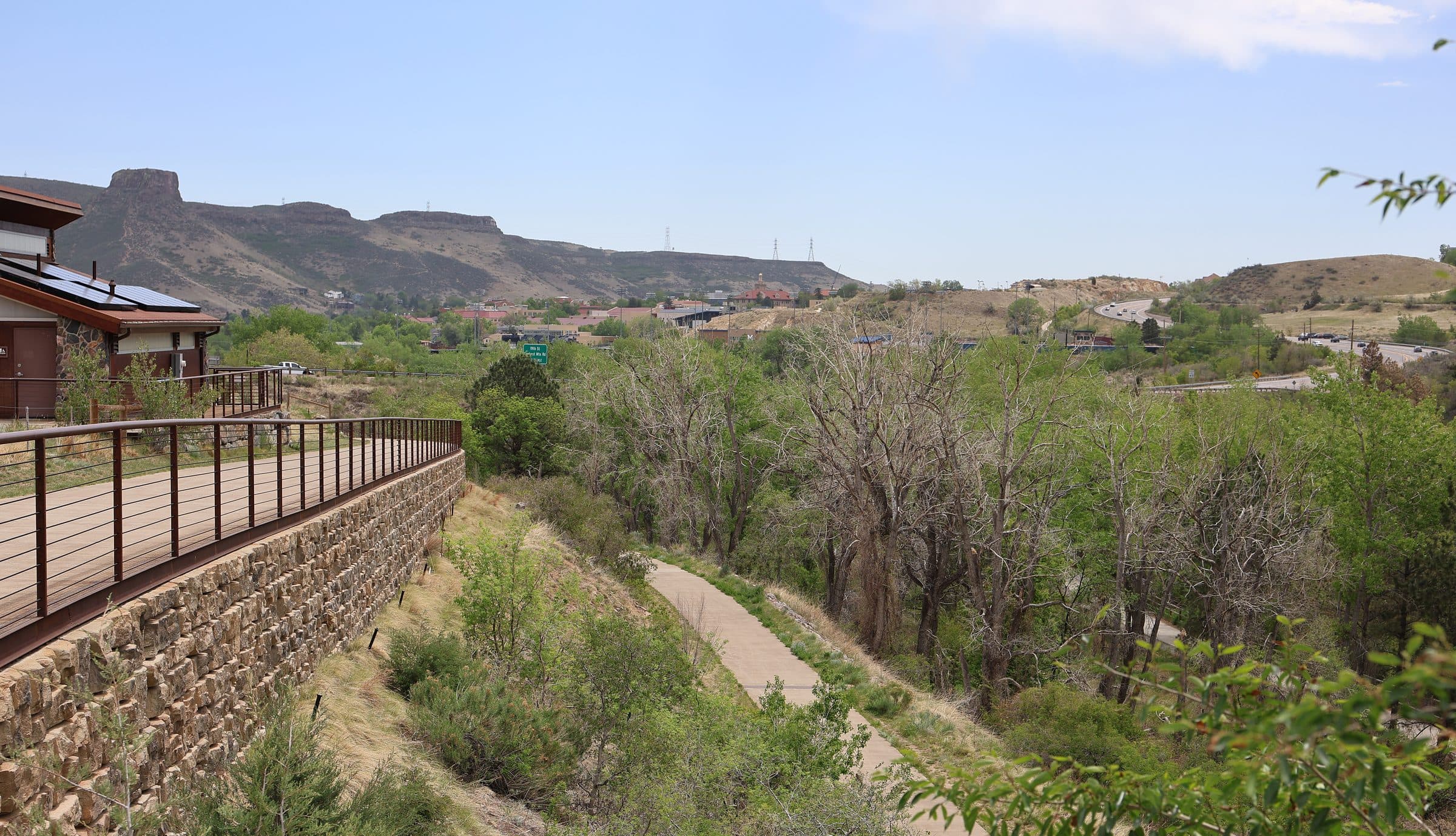 The railed ramp at the Gateway Trailhead dropping into a green desert wash below the McDowell Mountains
