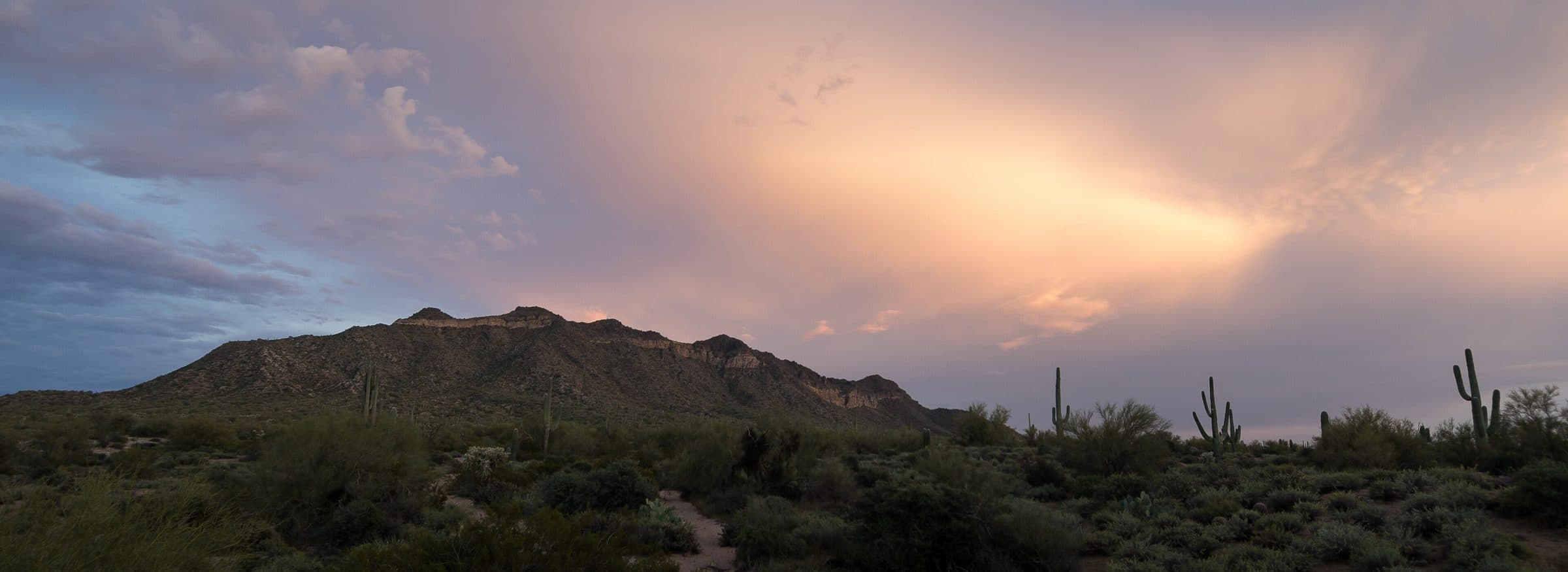 Pass Mountain silhouetted against a pink evening sky in Usery Mountain Regional Park